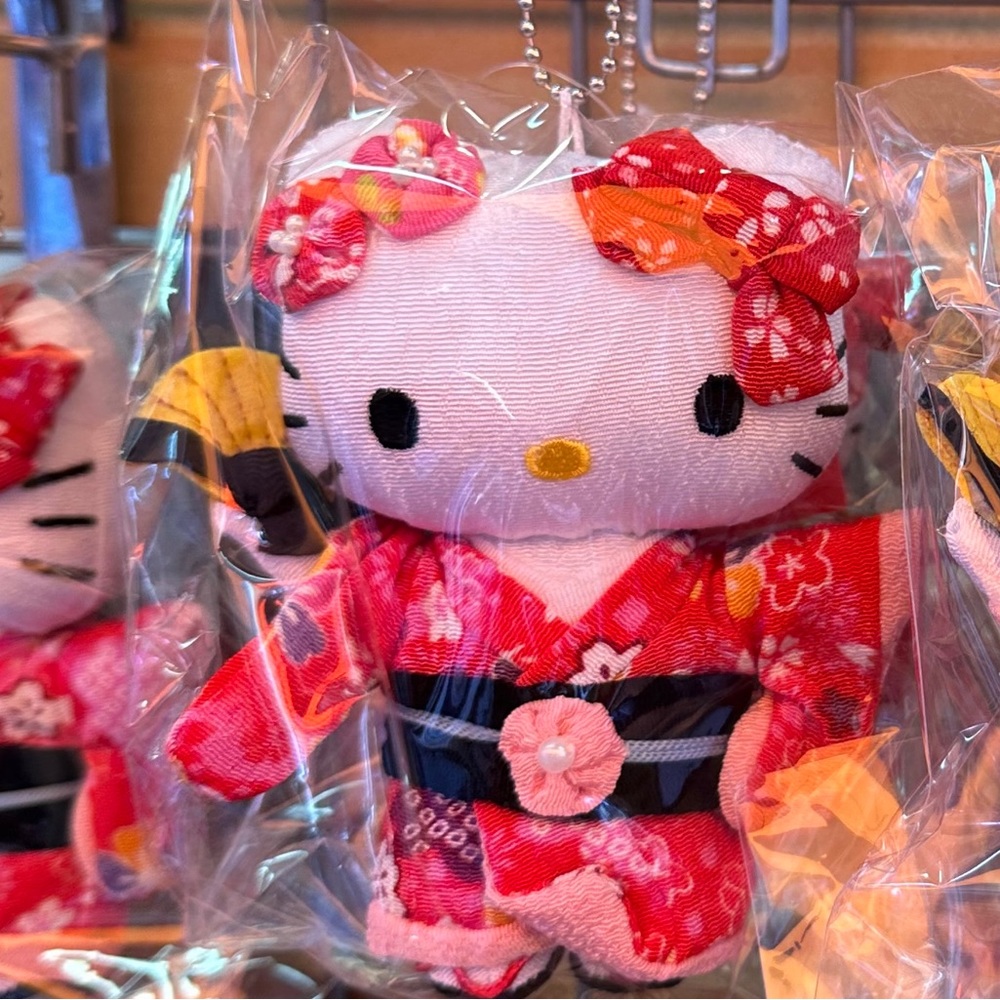 One small hello kitty from Japan wearing traditional clothing, wearing a kimono.